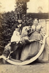 Young Girl on Large Rocking Horse with Man and Woman Standing, 1860s
